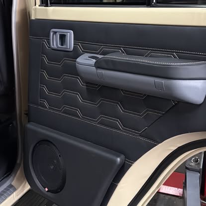 Custom door card with quilted trim and fitted speaker