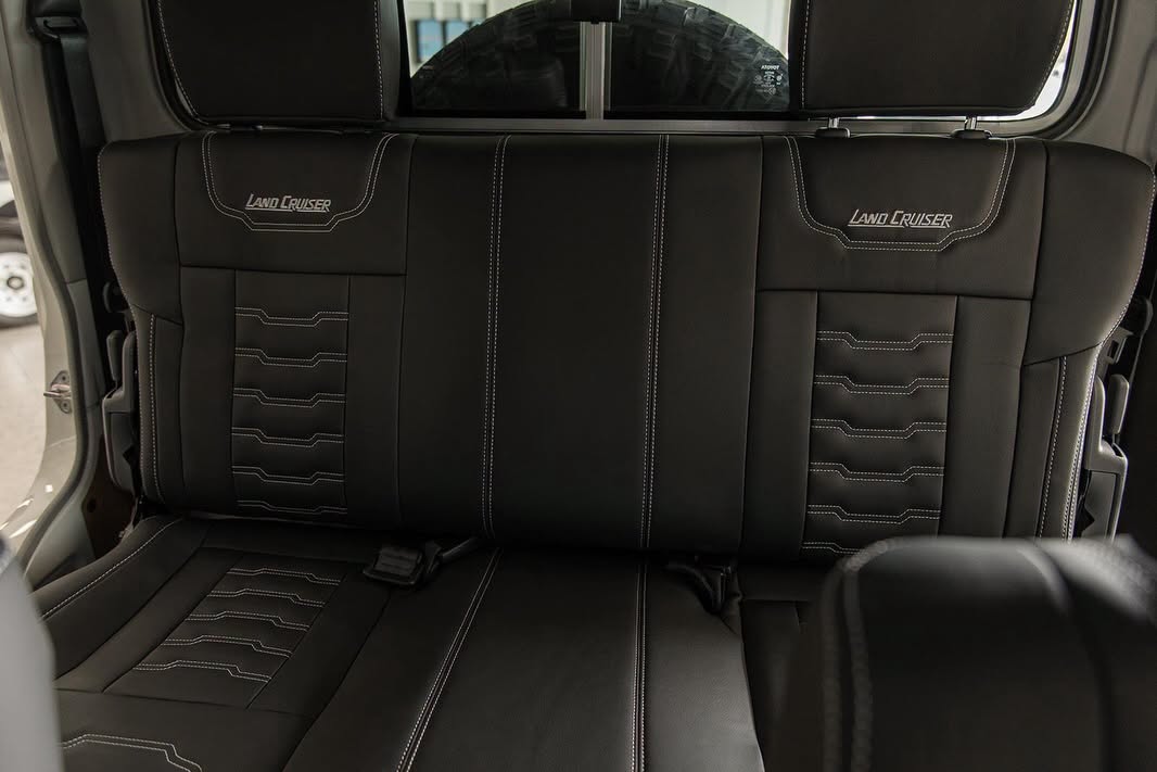 Custom-trimmed Land Cruiser rear bench with stitched panels