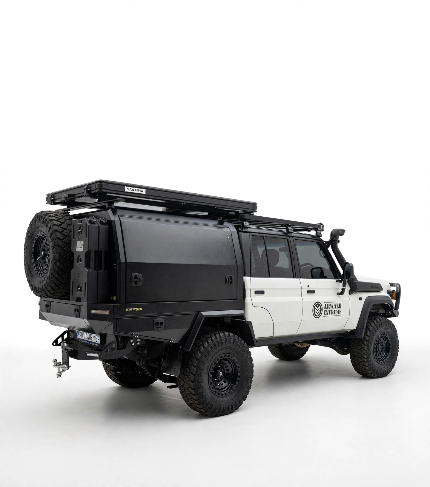 White Land Cruiser double-cab fitted with tray, canopy and rear carrier